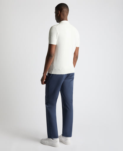 Man wearing a white Slim Fit Cotton Interest Fabric Polo Shirt