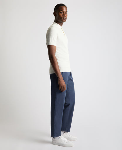 Man wearing a white Slim Fit Cotton Interest Fabric Polo Shirt