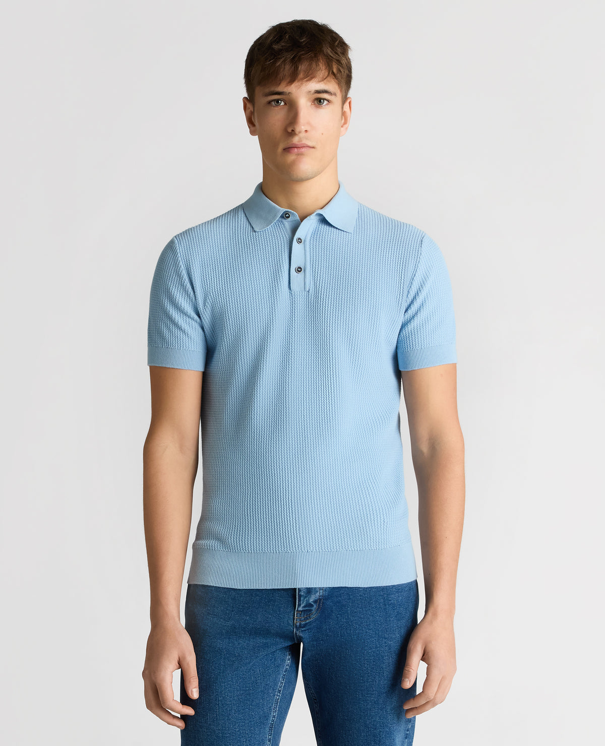 Man wearing a blue Slim Fit Cotton Interest Fabric Polo Shirt