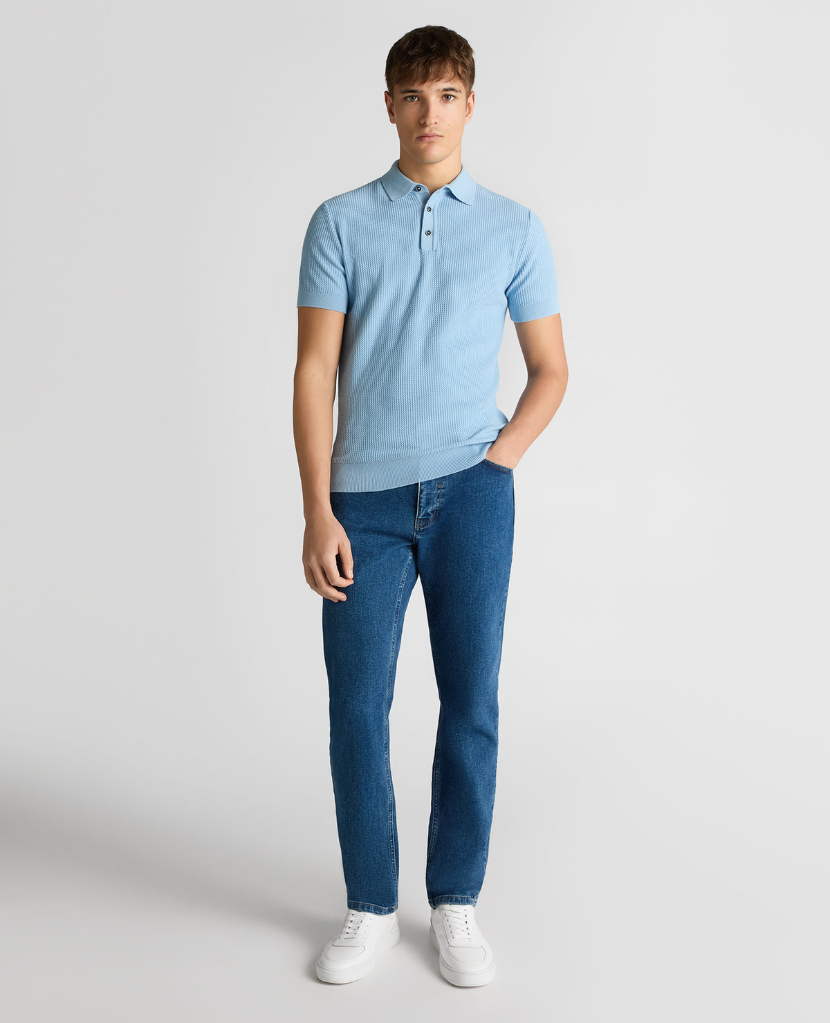 Man wearing a blue Slim Fit Cotton Interest Fabric Polo Shirt