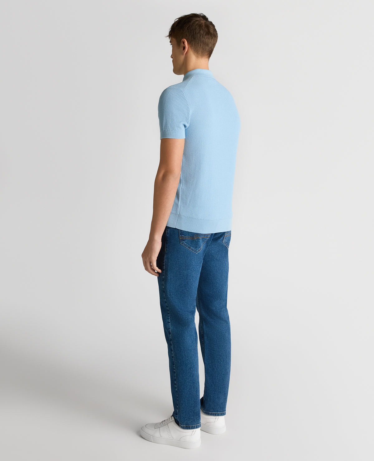 Man wearing a blue Slim Fit Cotton Interest Fabric Polo Shirt