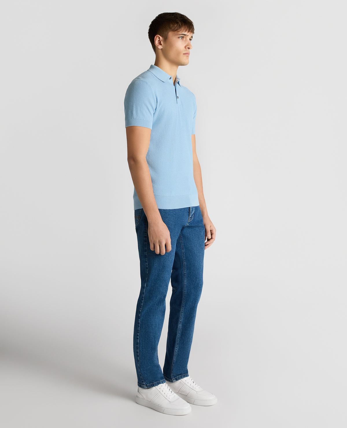 Man wearing a blue Slim Fit Cotton Interest Fabric Polo Shirt