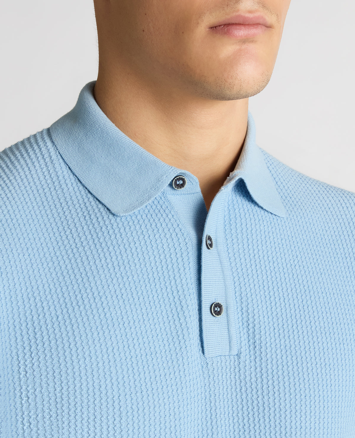 Man wearing a blue Slim Fit Cotton Interest Fabric Polo Shirt