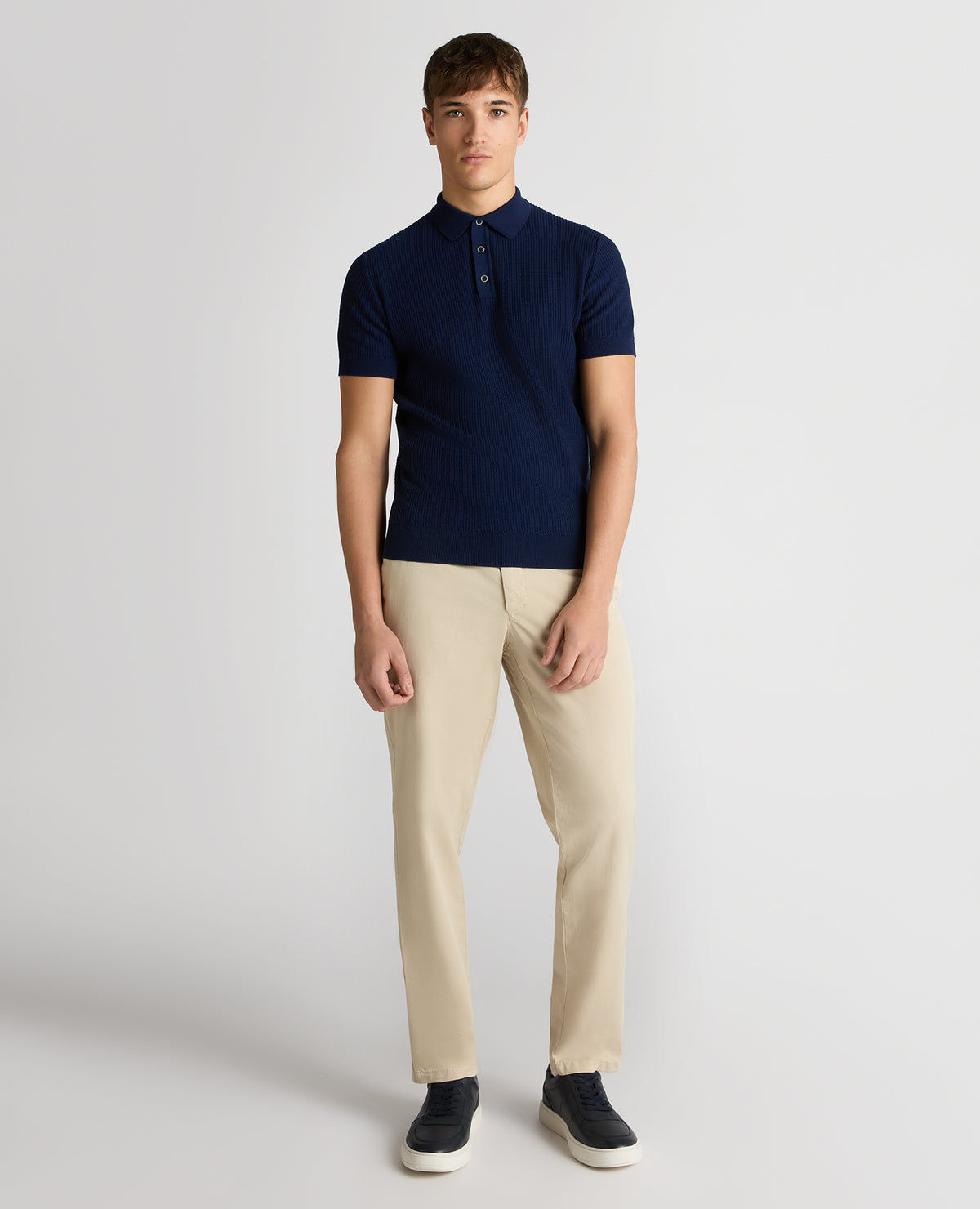 Man wearing a blue Slim Fit Cotton Interest Fabric Polo Shirt