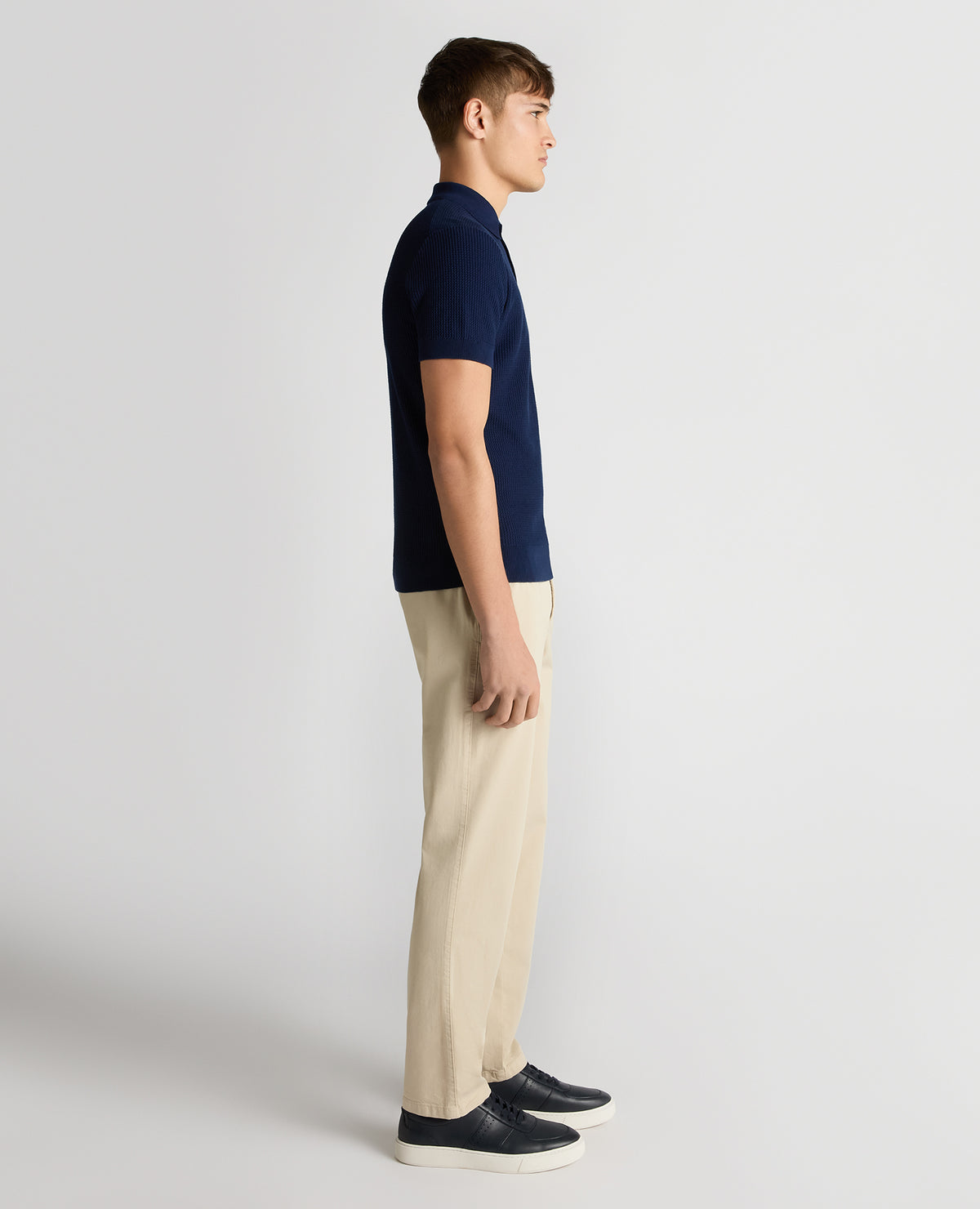 Man wearing a blue Slim Fit Cotton Interest Fabric Polo Shirt