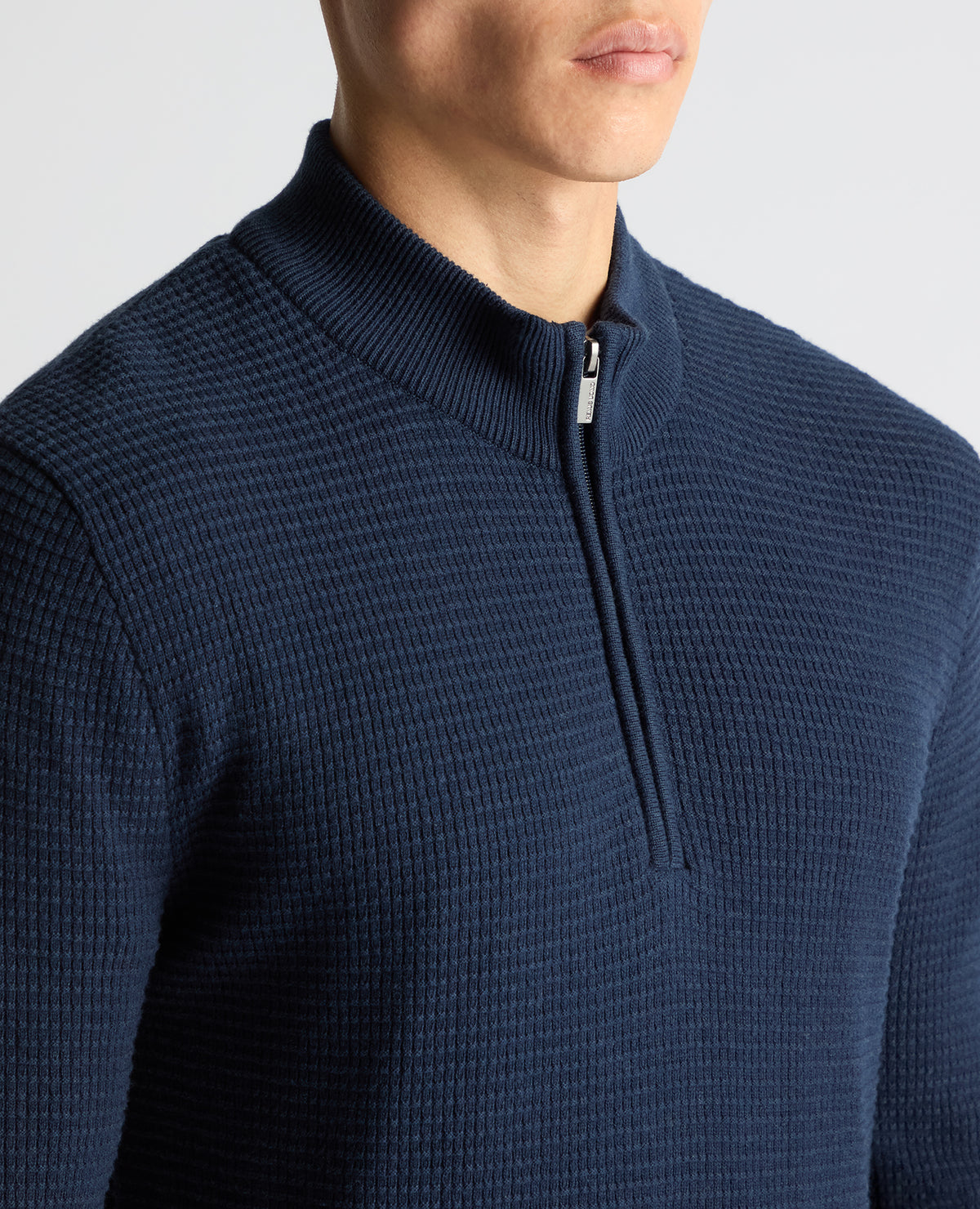 Man wearing a blue Tapered Fit Cotton Half Zip Sweater