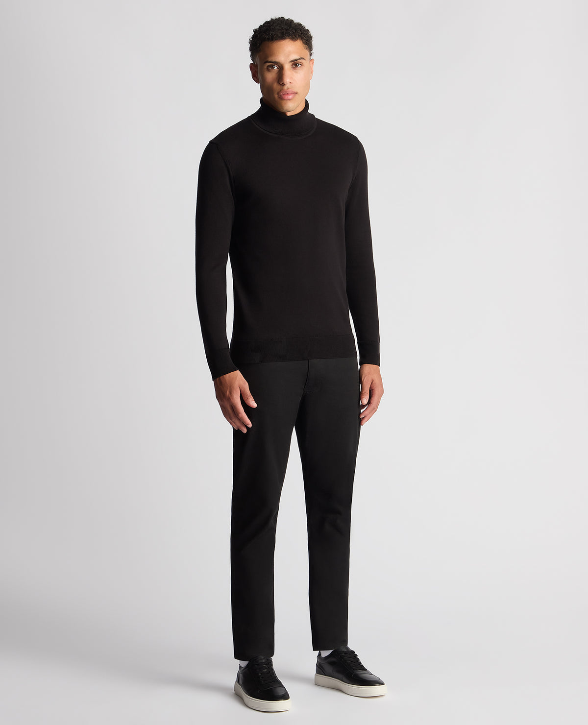 Man wearing a black Tapered Fit Roll Neck Sweater