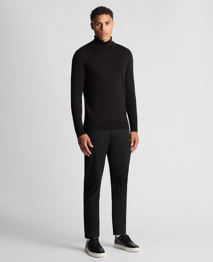 Man wearing a black Tapered Fit Roll Neck Sweater
