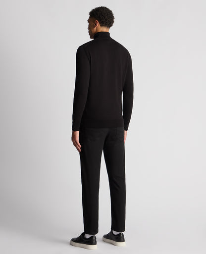 Man wearing a black Tapered Fit Roll Neck Sweater