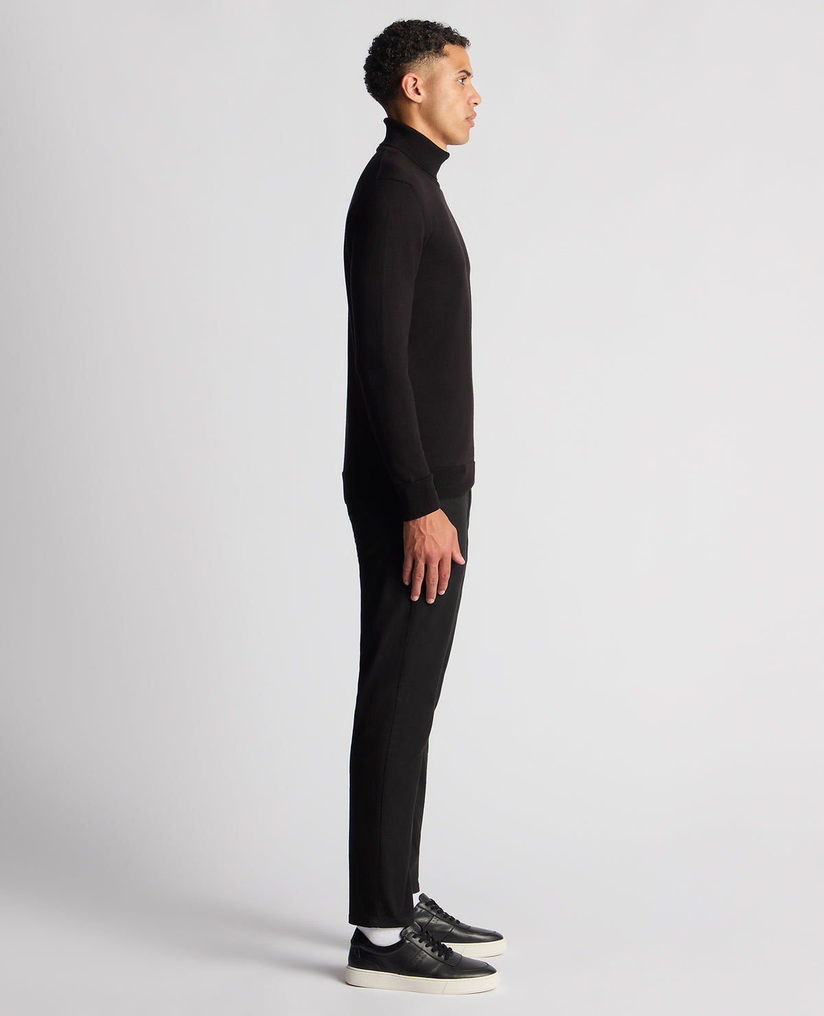 Man wearing a black Tapered Fit Roll Neck Sweater