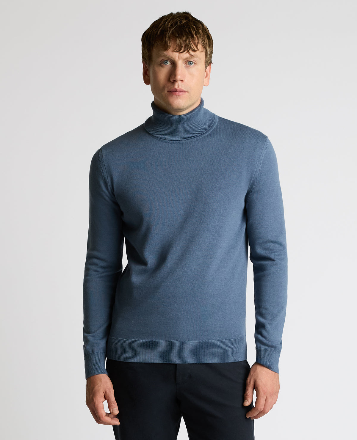 Man wearing a blue Roll Neck Cotton Sweater