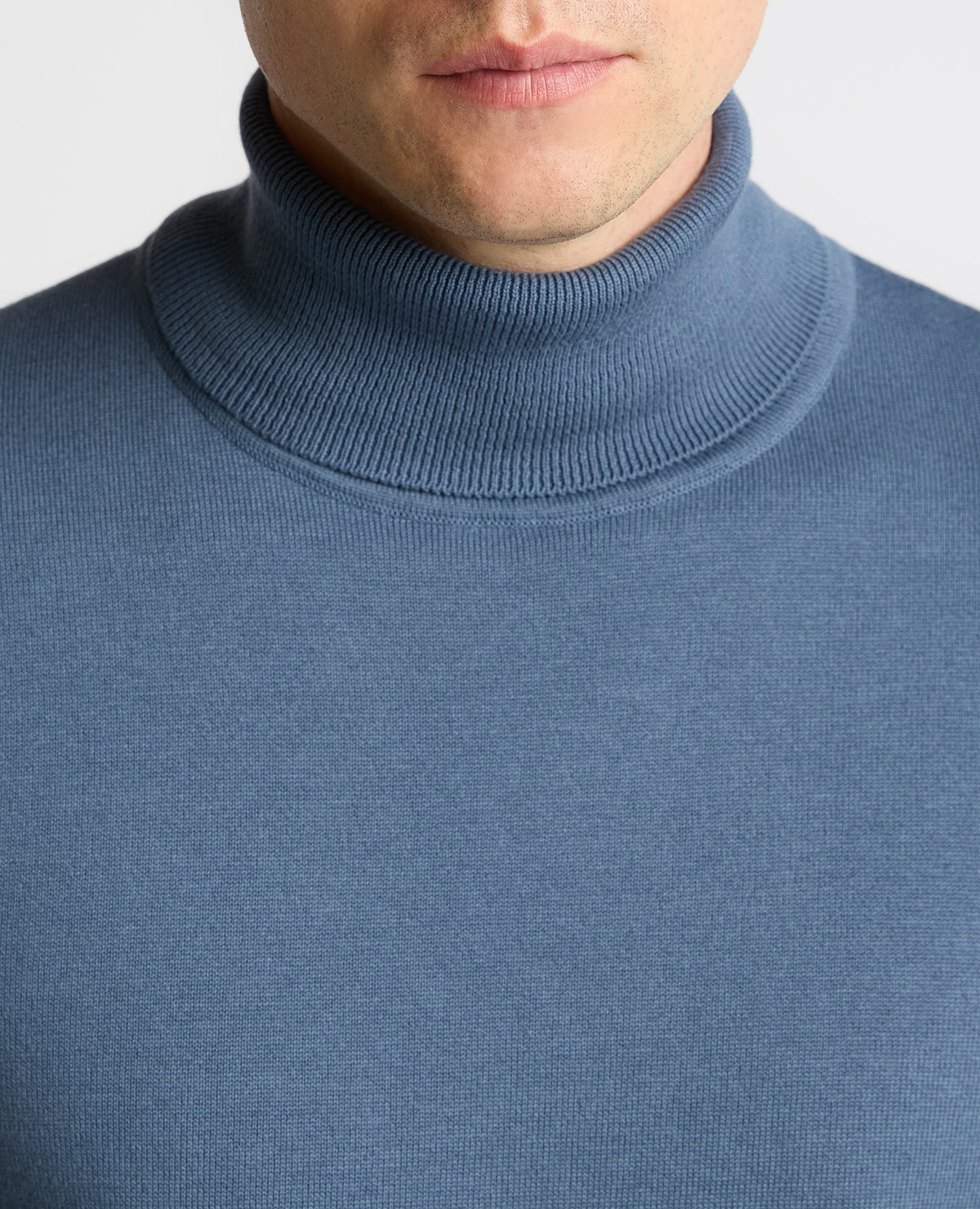 Man wearing a blue Roll Neck Cotton Sweater