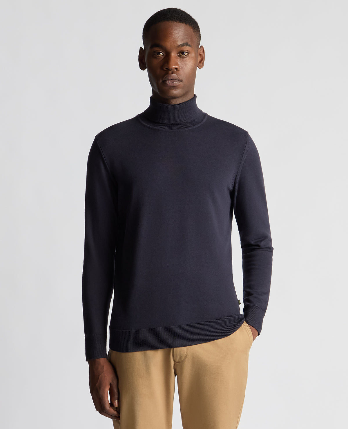 Man wearing a blue Tapered Fit Roll Neck Sweater