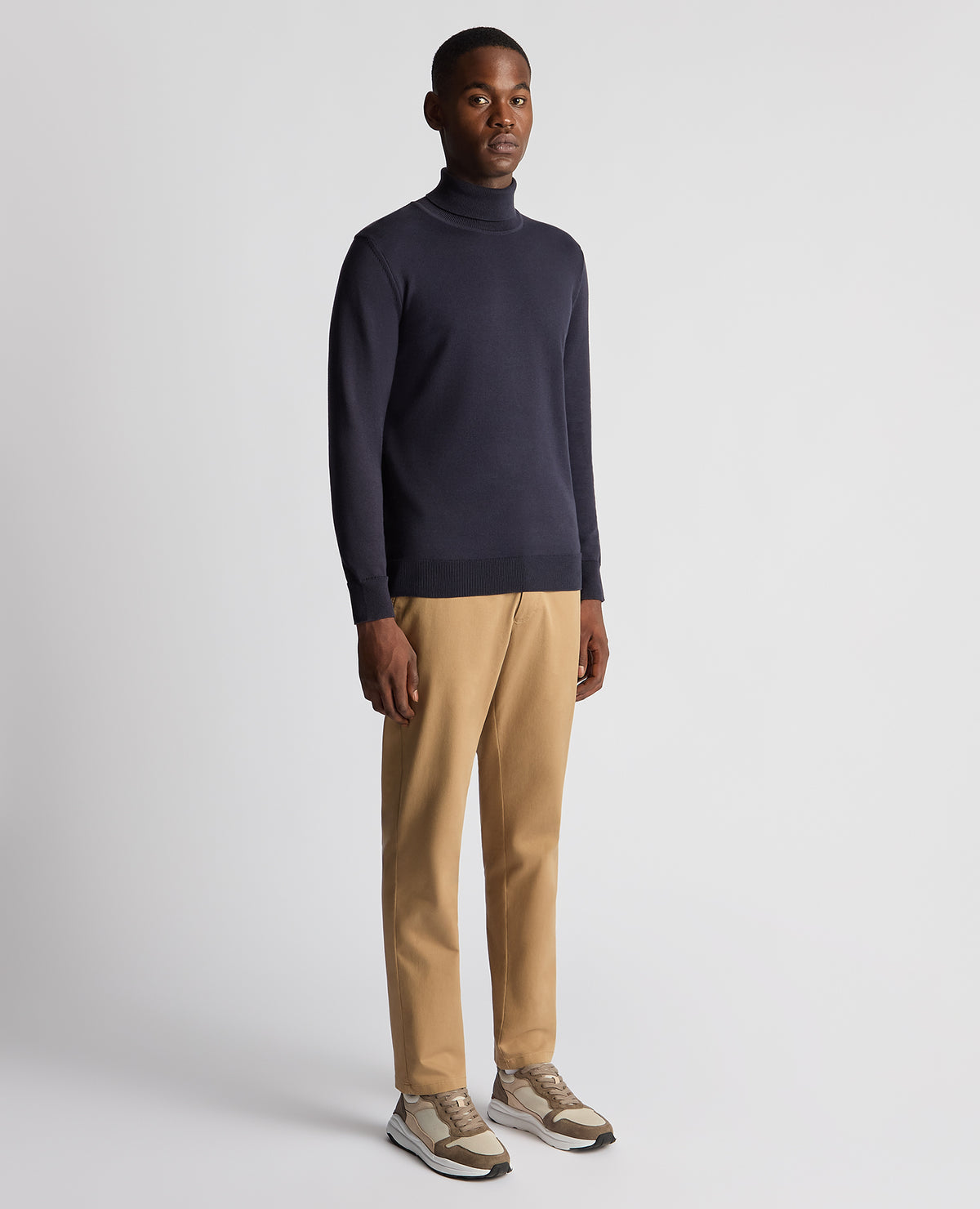 Man wearing a blue Tapered Fit Roll Neck Sweater