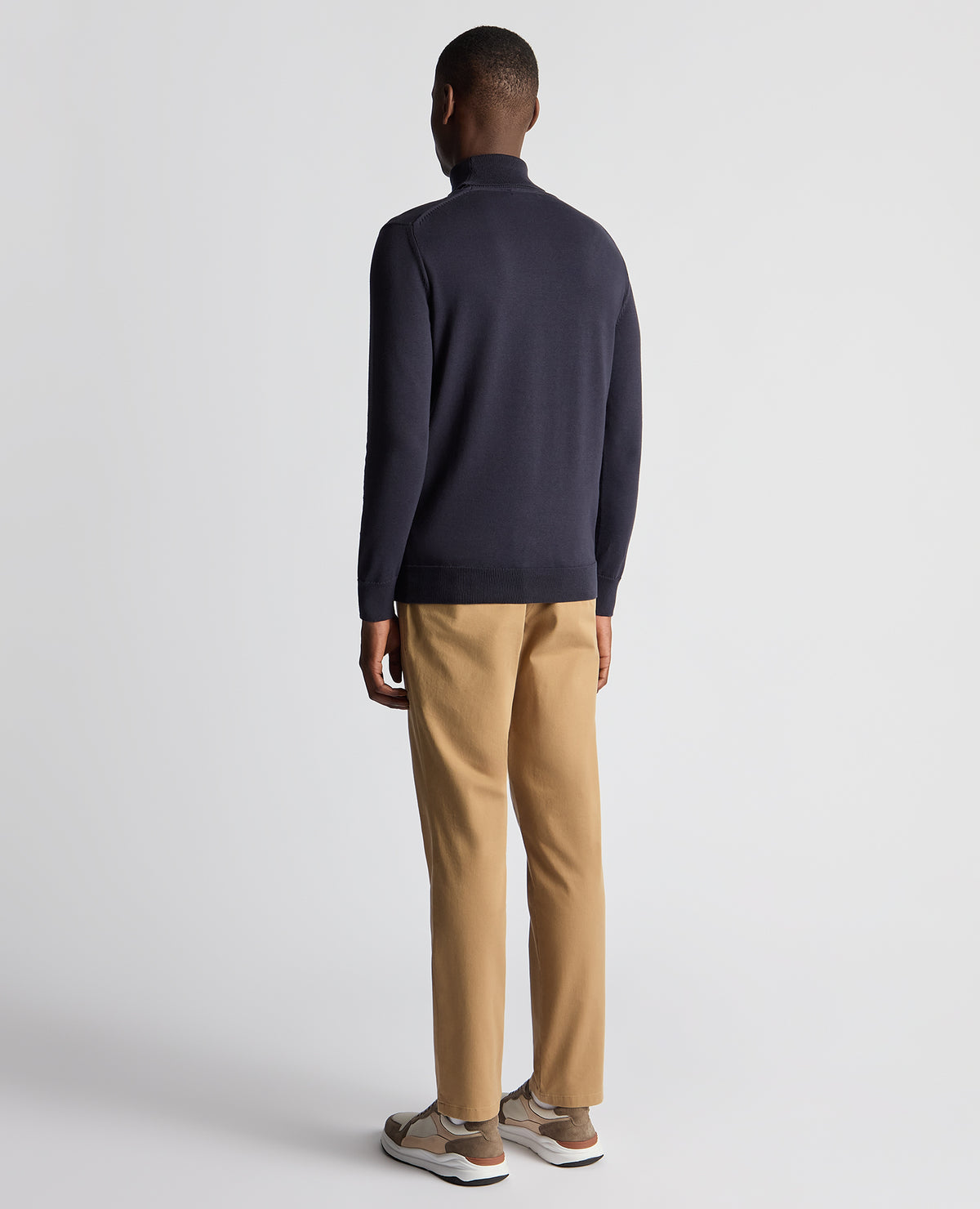 Man wearing a blue Tapered Fit Roll Neck Sweater