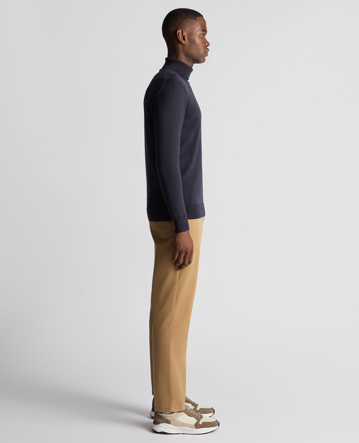 Man wearing a blue Tapered Fit Roll Neck Sweater