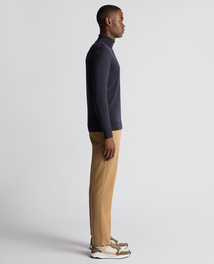 Man wearing a blue Tapered Fit Roll Neck Sweater