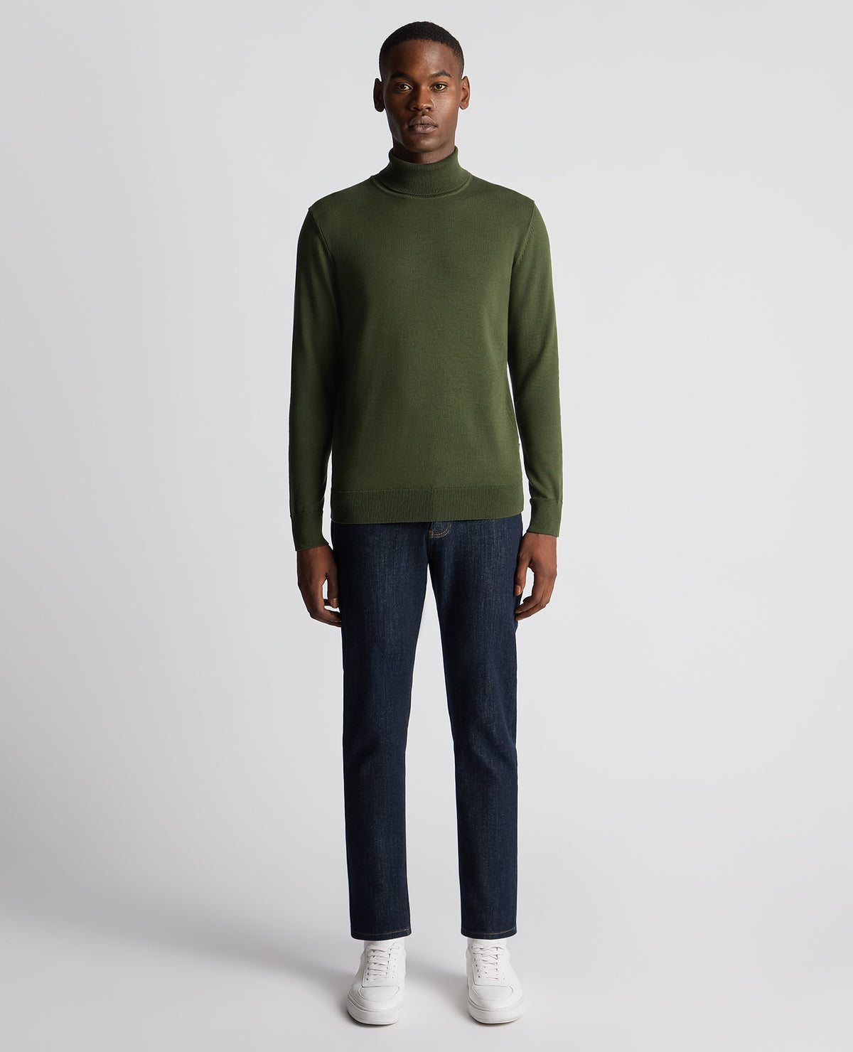 Man wearing a green Tapered Fit Roll Neck Sweater
