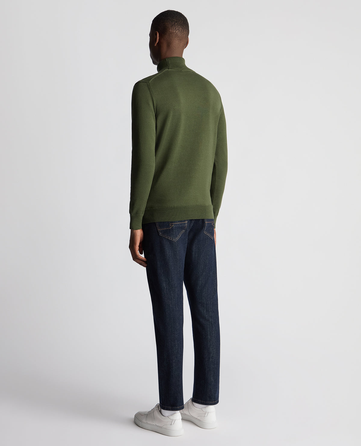 Man wearing a green Tapered Fit Roll Neck Sweater