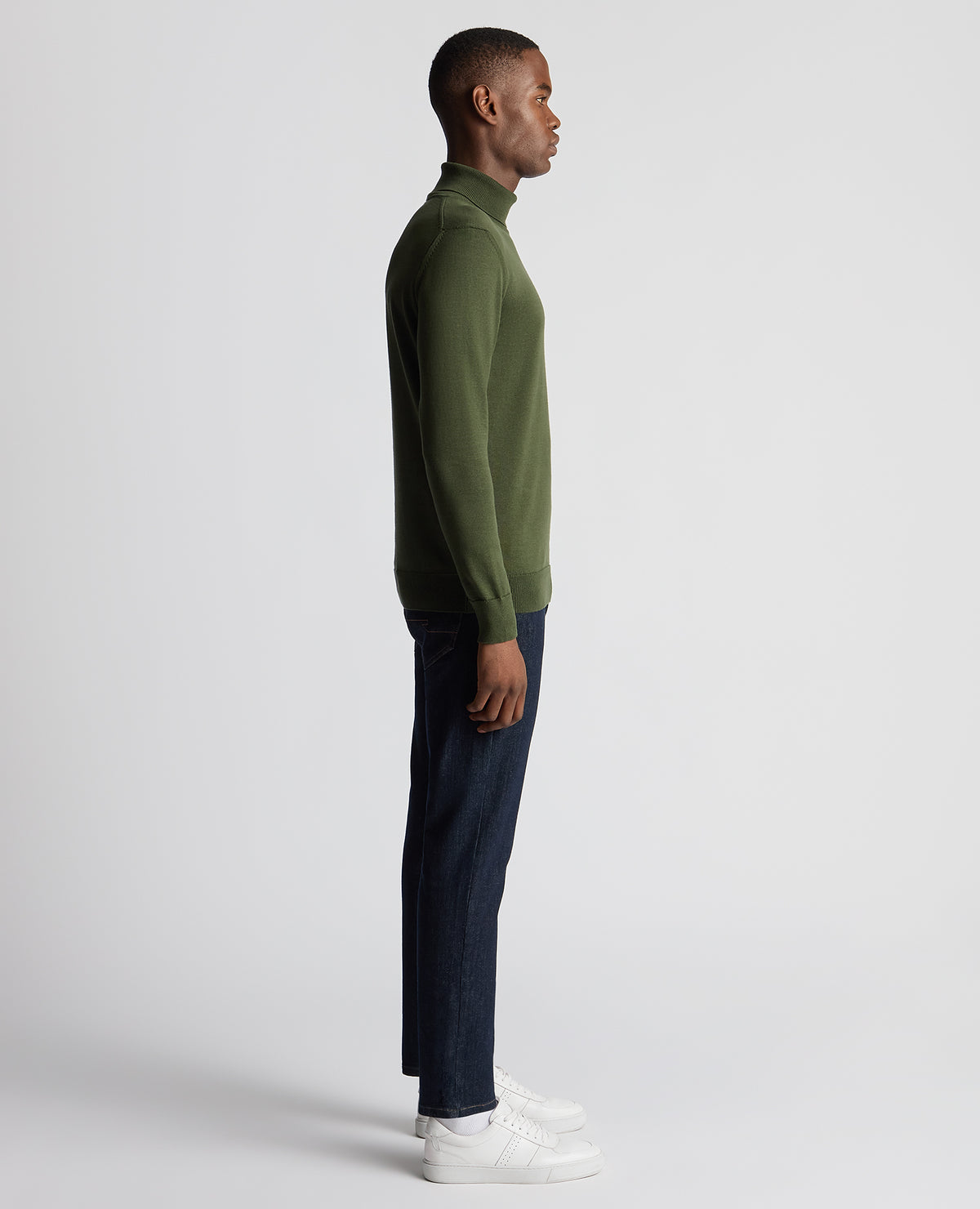 Man wearing a green Tapered Fit Roll Neck Sweater