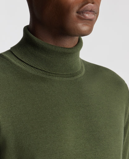 Man wearing a green Tapered Fit Roll Neck Sweater
