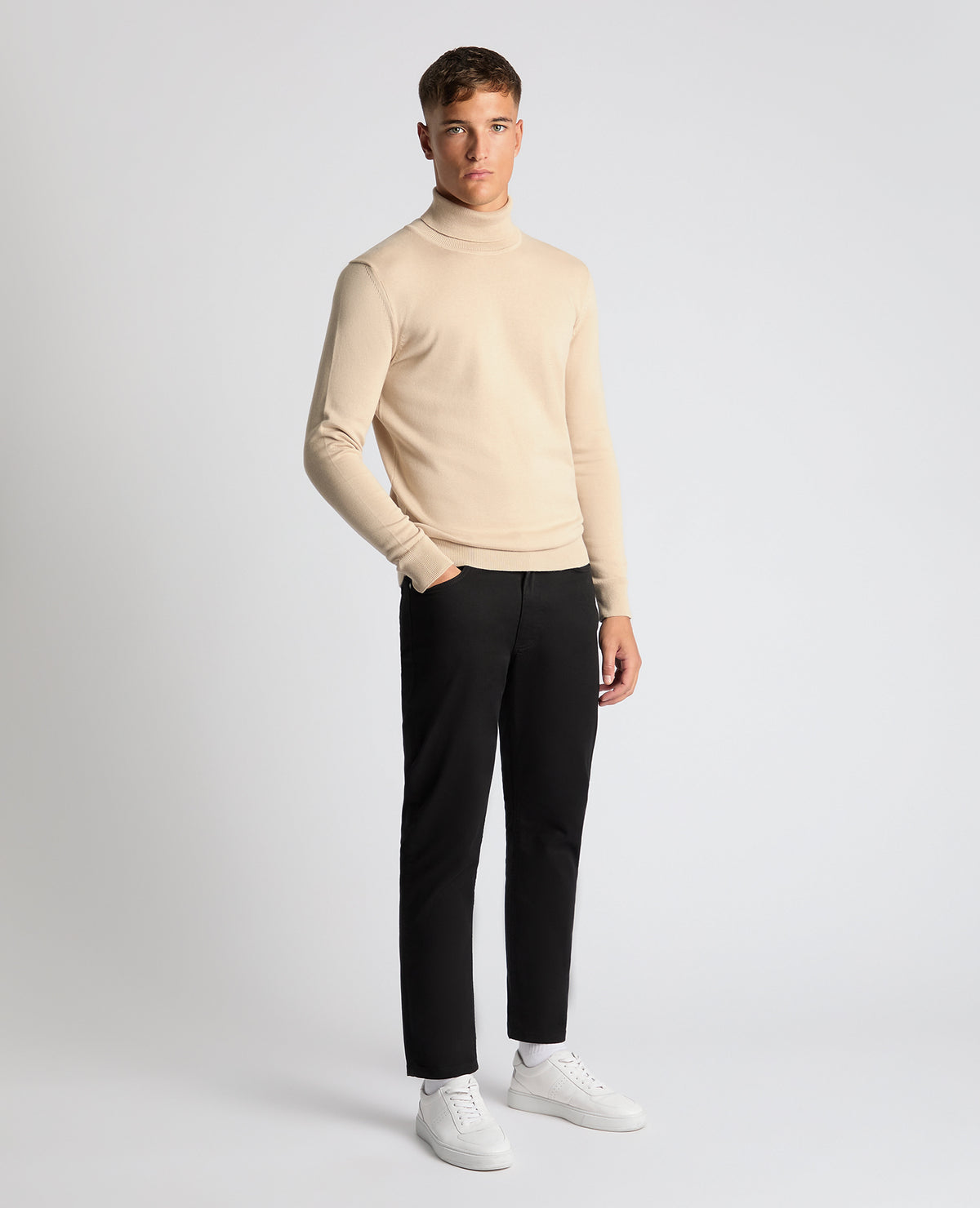 Man wearing a sand Tapered Fit Roll Neck Sweater