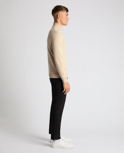 Man wearing a sand Tapered Fit Roll Neck Sweater