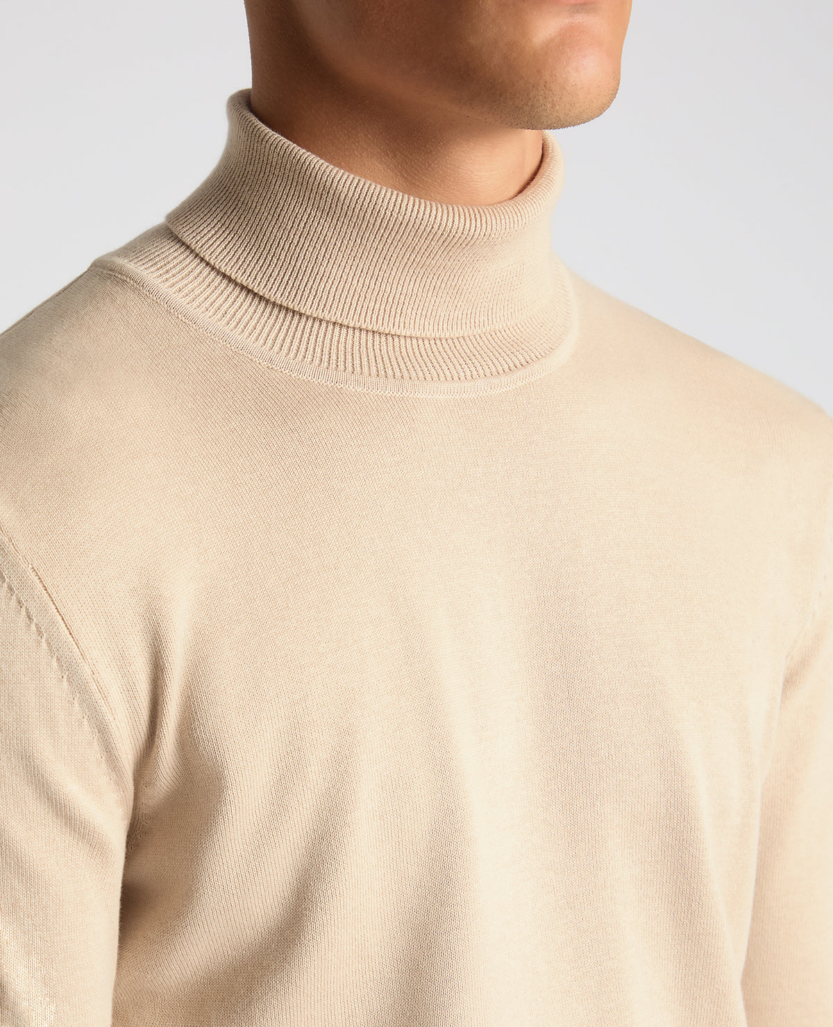 Man wearing a sand Tapered Fit Roll Neck Sweater