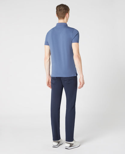 Man wearing a blue Tapered Fit Cotton-Stretch Polo Shirt