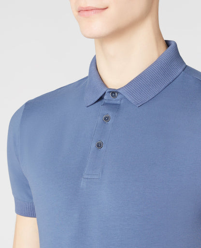 Man wearing a blue Tapered Fit Cotton-Stretch Polo Shirt