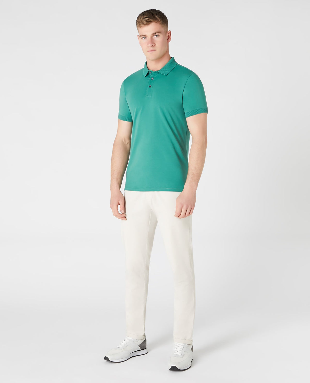 Man wearing a green Tapered Fit Cotton-Stretch Polo Shirt