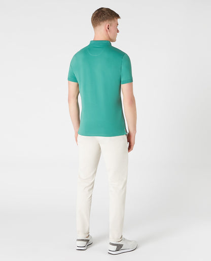 Man wearing a green Tapered Fit Cotton-Stretch Polo Shirt