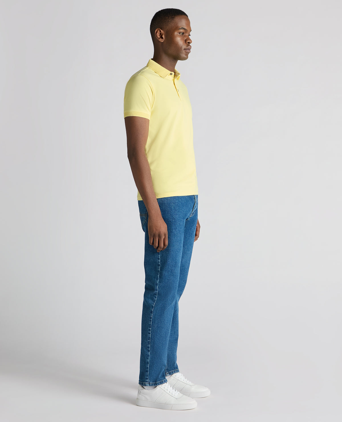 Man wearing a orange Tapered Fit Cotton-Stretch Polo Shirt