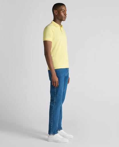 Man wearing a orange Tapered Fit Cotton-Stretch Polo Shirt