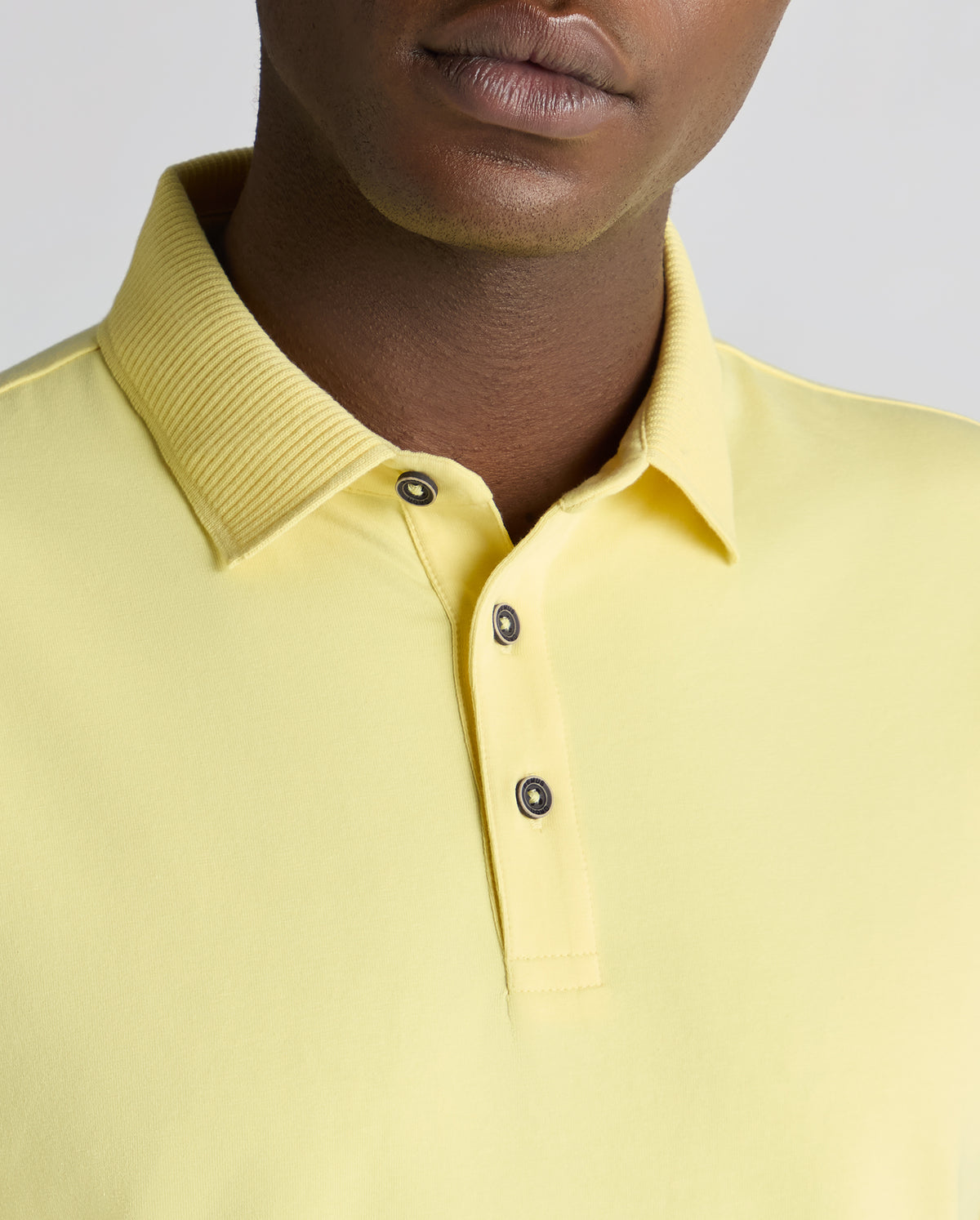 Man wearing a orange Tapered Fit Cotton-Stretch Polo Shirt