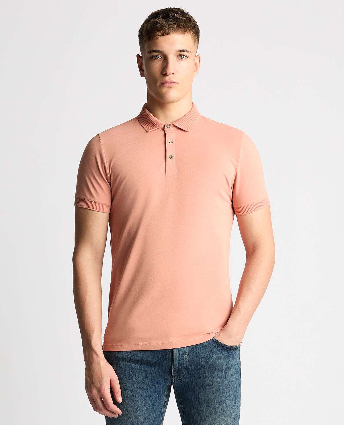 Man wearing a red Tapered Fit Cotton-Stretch Polo Shirt