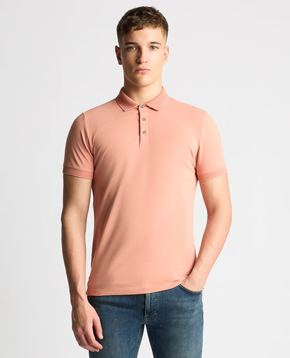Man wearing a red Tapered Fit Cotton-Stretch Polo Shirt