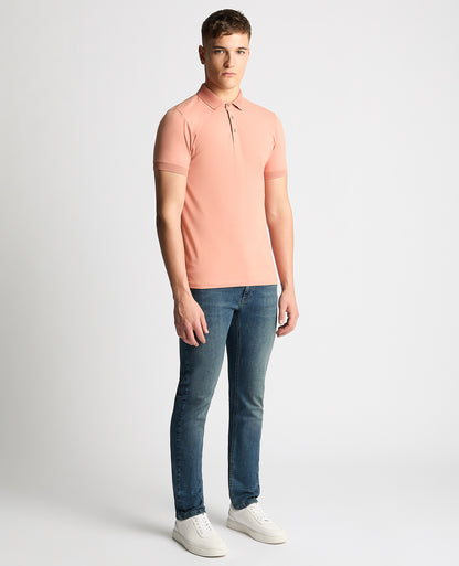 Man wearing a red Tapered Fit Cotton-Stretch Polo Shirt