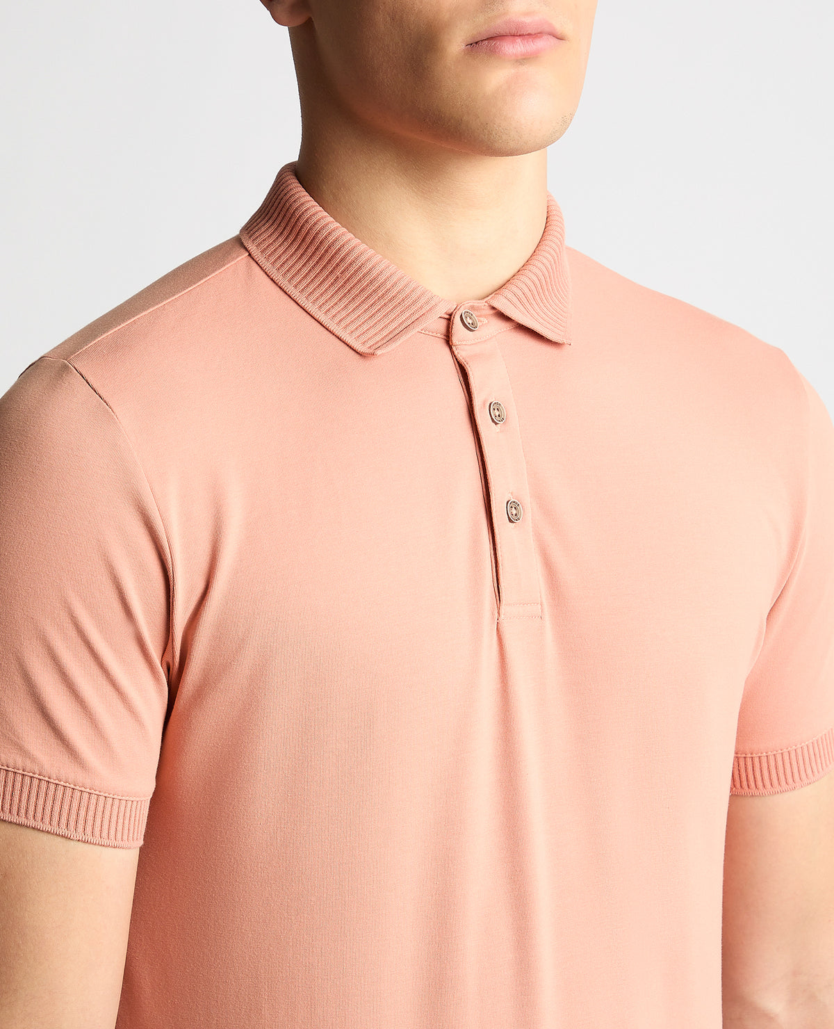 Man wearing a red Tapered Fit Cotton-Stretch Polo Shirt