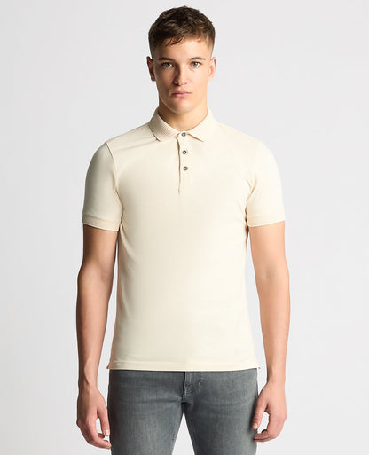 Man wearing a sand Tapered Fit Cotton-Stretch Polo Shirt