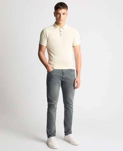 Man wearing a sand Tapered Fit Cotton-Stretch Polo Shirt