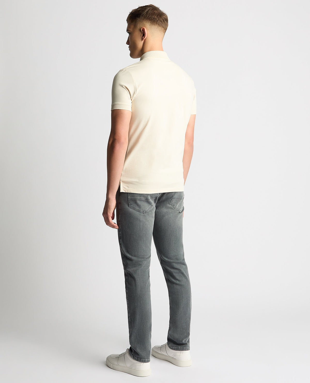 Man wearing a sand Tapered Fit Cotton-Stretch Polo Shirt
