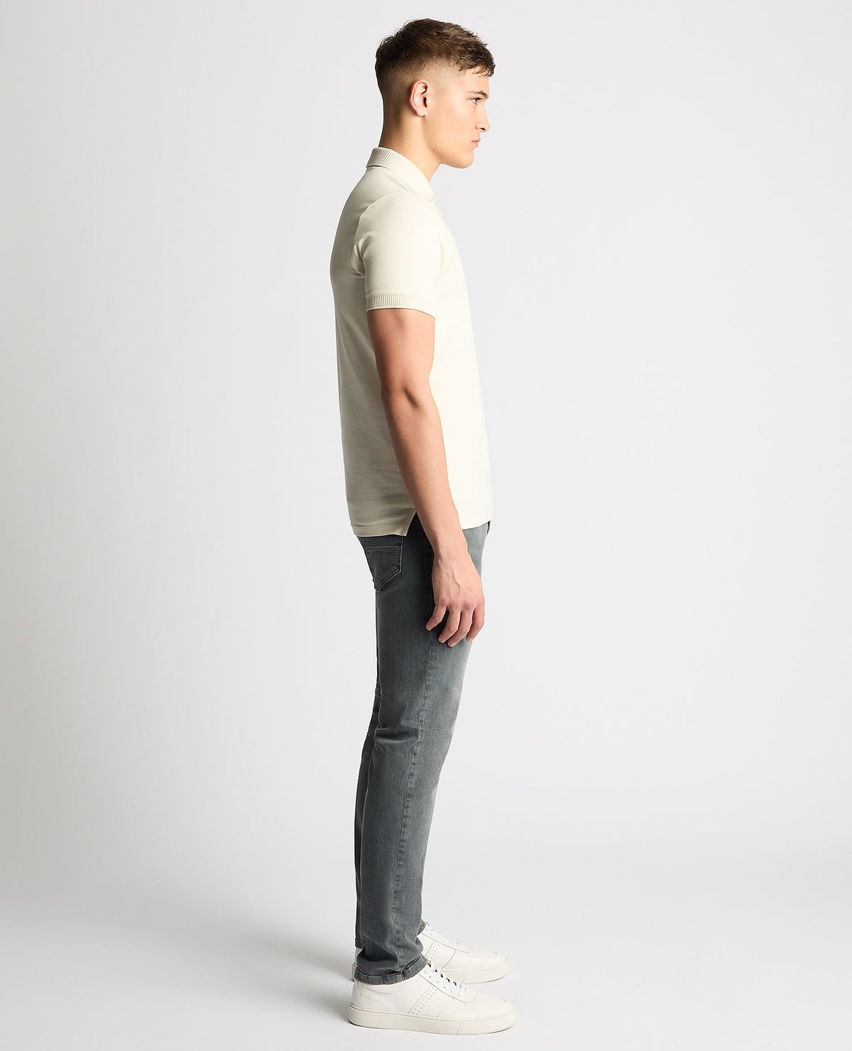 Man wearing a sand Tapered Fit Cotton-Stretch Polo Shirt