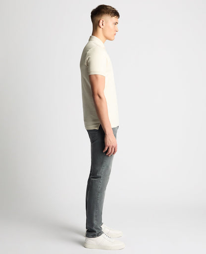 Man wearing a sand Tapered Fit Cotton-Stretch Polo Shirt