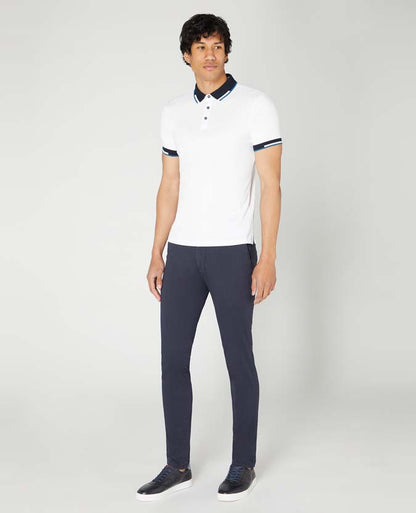 Man wearing a white Tapered Fit Cotton-Stretch Pique Polo Shirt