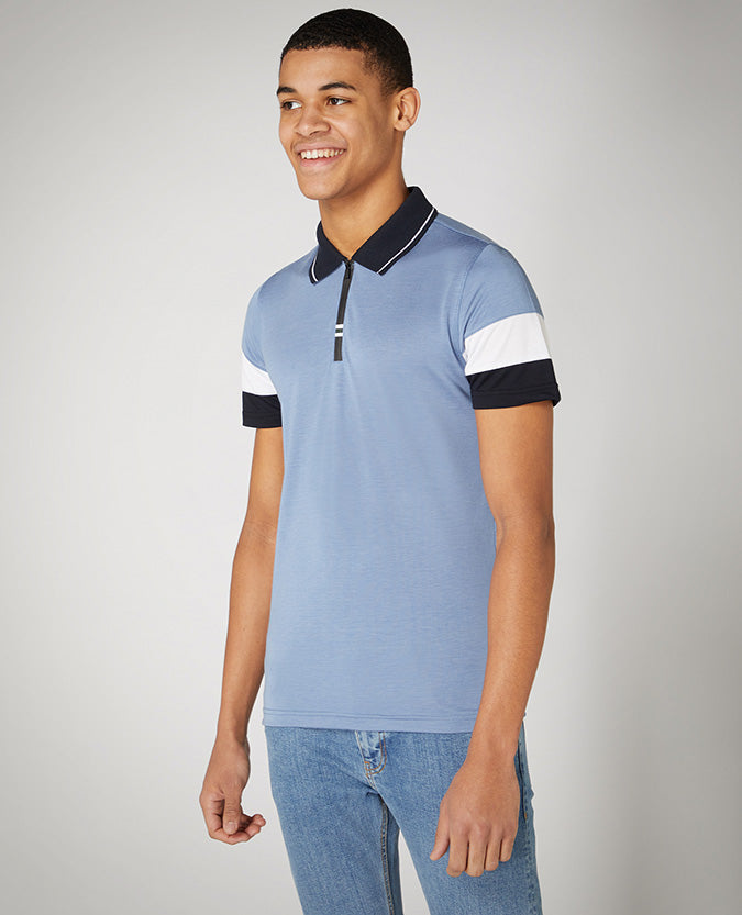 Man wearing a blue Tapered Fit Cotton-Stretch Jersey Polo Shirt