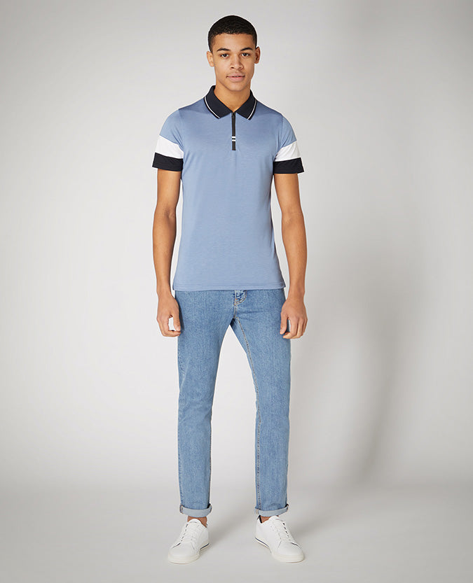 Man wearing a blue Tapered Fit Cotton-Stretch Jersey Polo Shirt