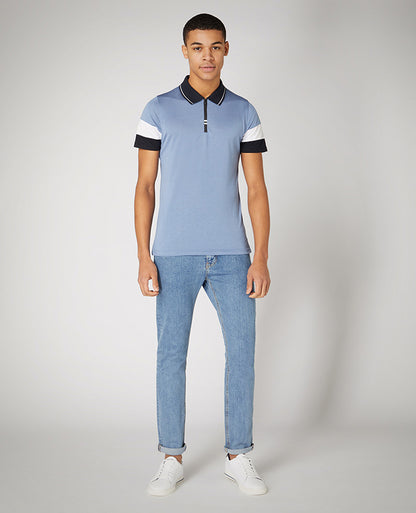 Man wearing a blue Tapered Fit Cotton-Stretch Jersey Polo Shirt