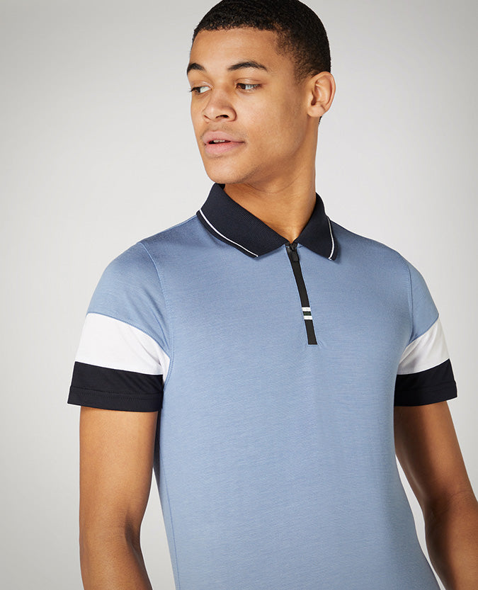 Man wearing a blue Tapered Fit Cotton-Stretch Jersey Polo Shirt