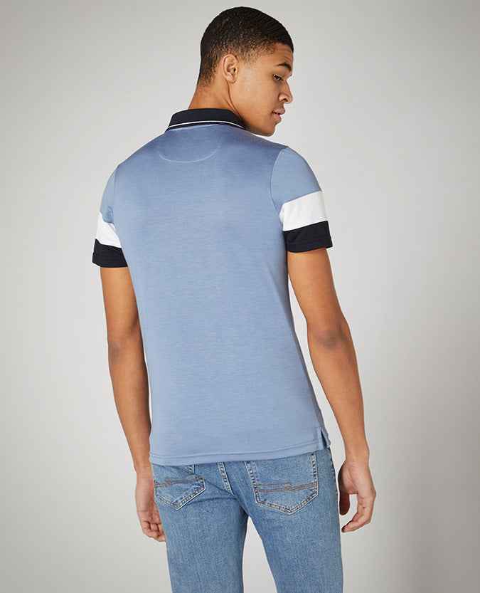Man wearing a blue Tapered Fit Cotton-Stretch Jersey Polo Shirt